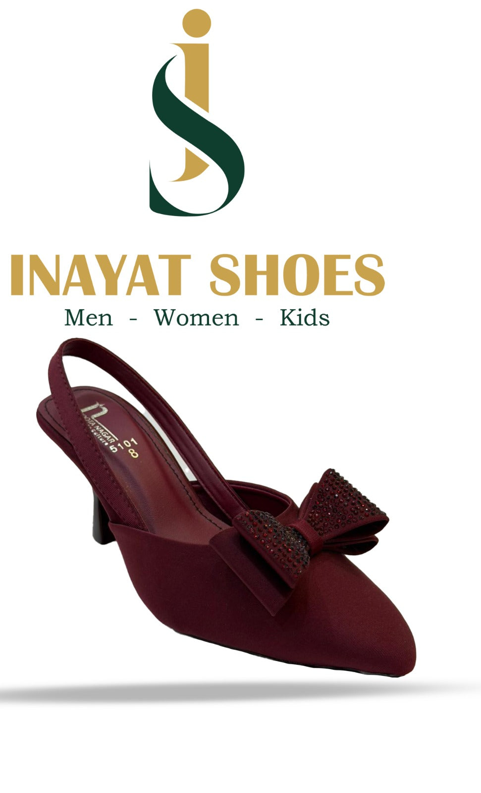 A model wearing black pointed-toe dressy flats with a sparkling pearl strap, styled with formal trousers.