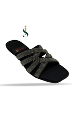 Black sandal with decorative straps on a white background