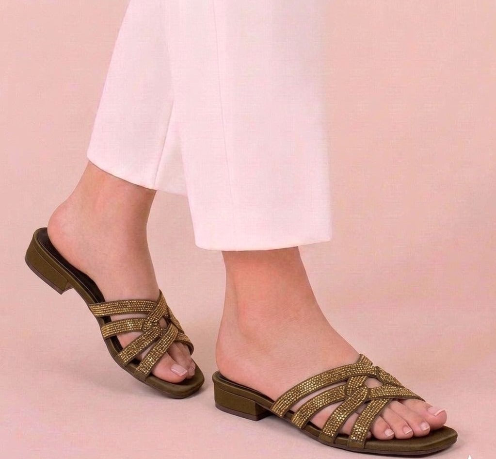 Olive green fashion slides with crystal criss-cross straps on a model.