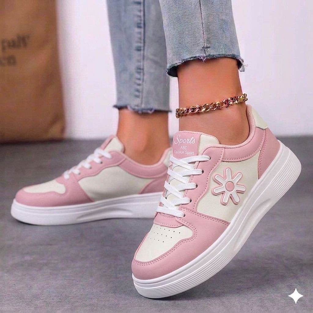 Close-up of the star pattern and floral stitching on the side of a chunky white fashion sneaker.