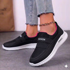 Black women's walking shoes with pink interior lining and flexible cushioned outsole.