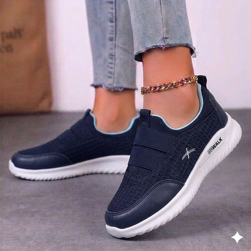 Top-down view of white floral lace-up sneakers showing the clean toe cap and comfortable fit.