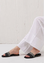 Elegant transparent pointed-toe slingback flats with oversized crystal heart embellishment.