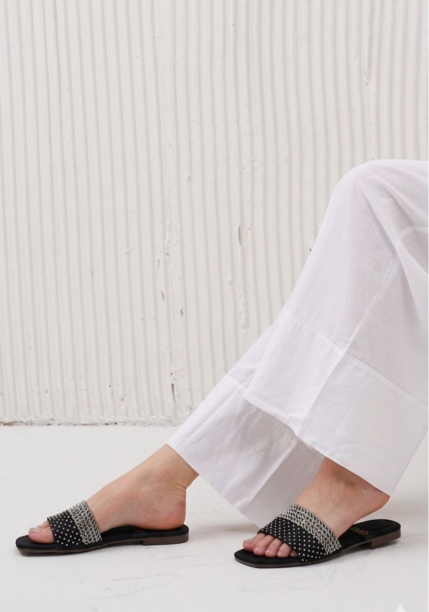 Elegant transparent pointed-toe slingback flats with oversized crystal heart embellishment.