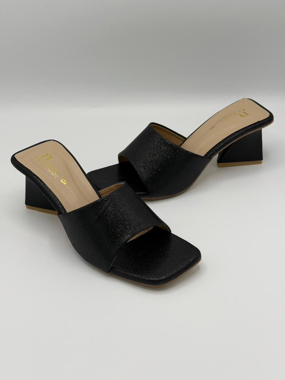 Black open-toe high-heeled sandals on a light gray background