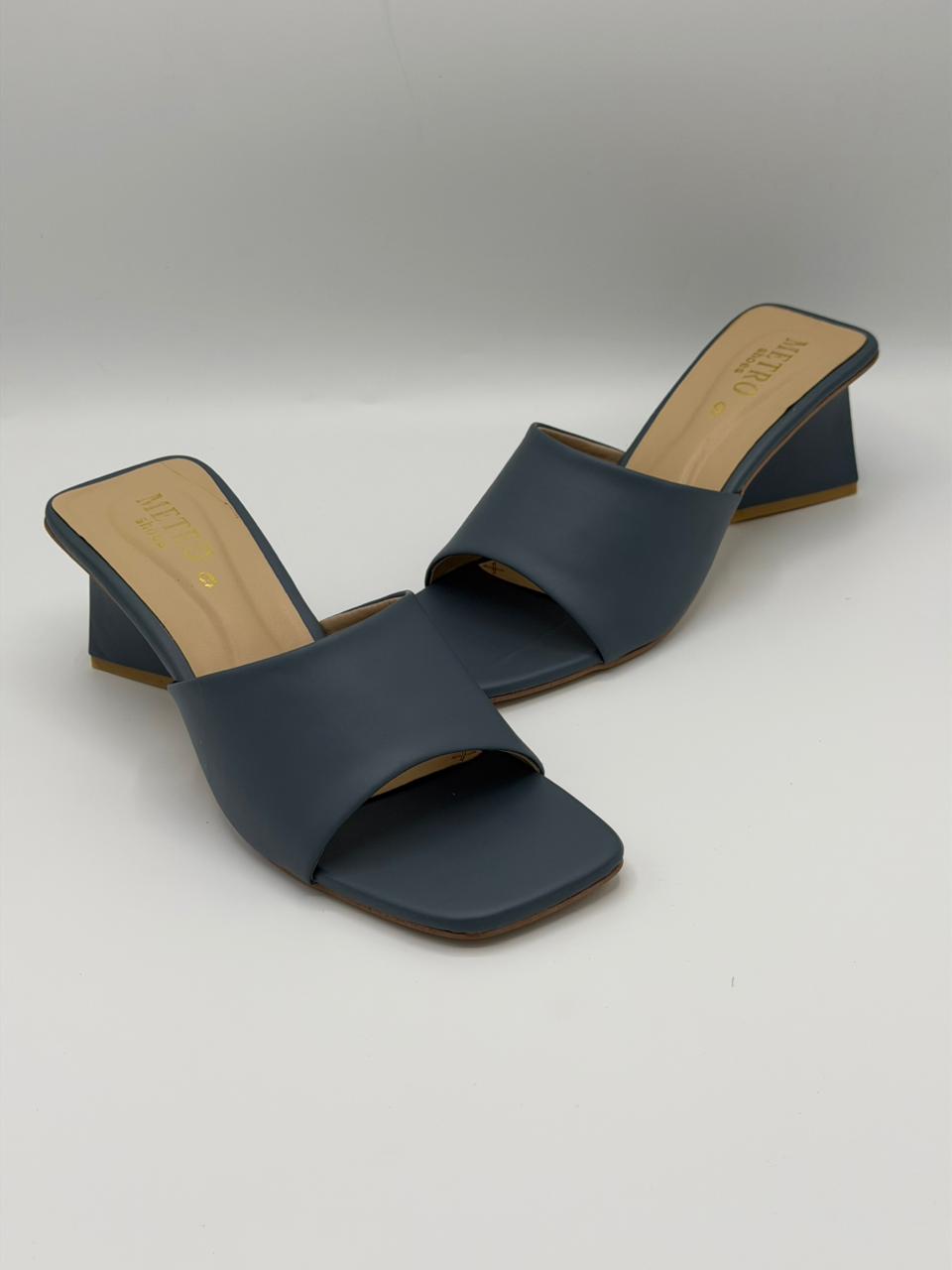 Pair of navy blue sandals on a light gray background