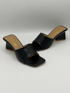 Black open-toe high-heeled sandals on a white background