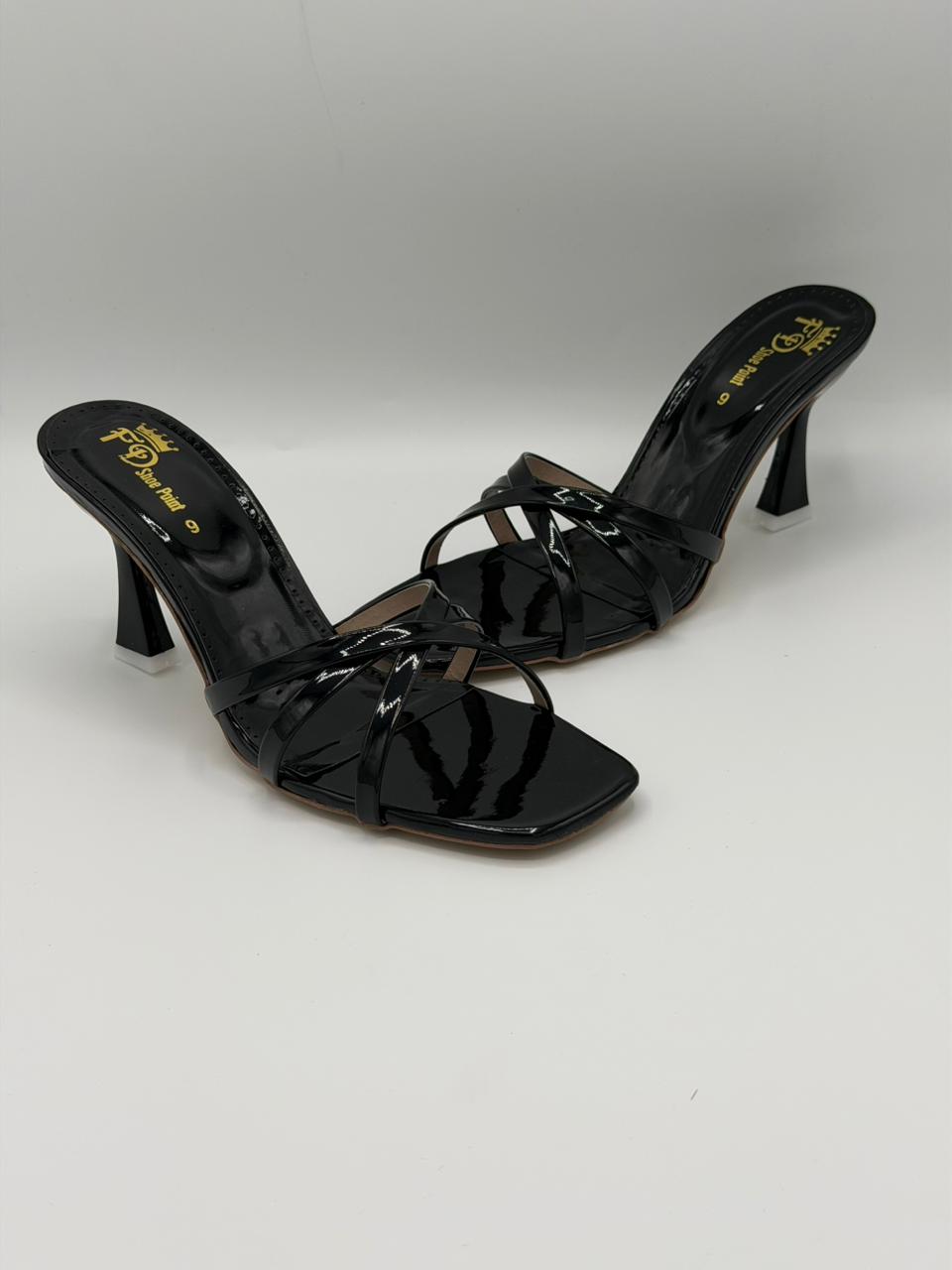 Black patent leather high-heeled shoes on a white background