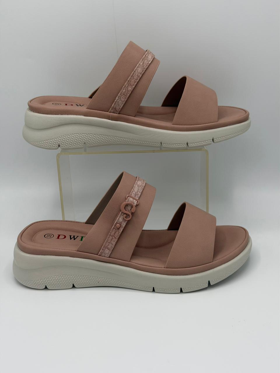 Pair of brown sandals with white soles on a white background