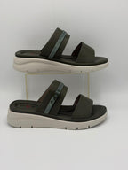 Pair of brown sandals with white soles on a white background