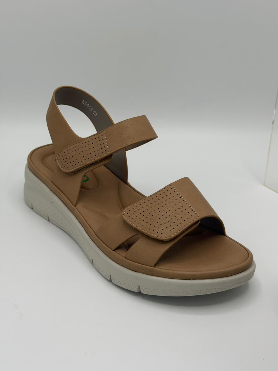 Brown sandal with a white sole on a light gray background