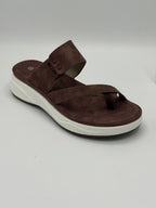 Brown sandal with white sole on a light gray background