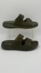 Pair of green sandals on a clear stand against a white background
