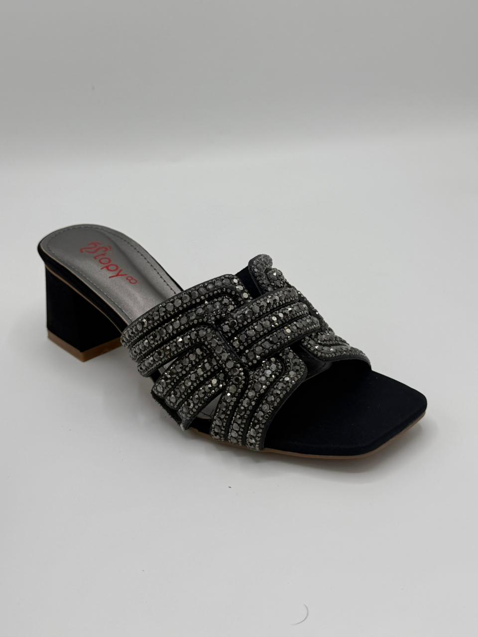 Black sandal with rhinestone embellishments on a white background