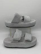 Silver glitter sandals on a white background