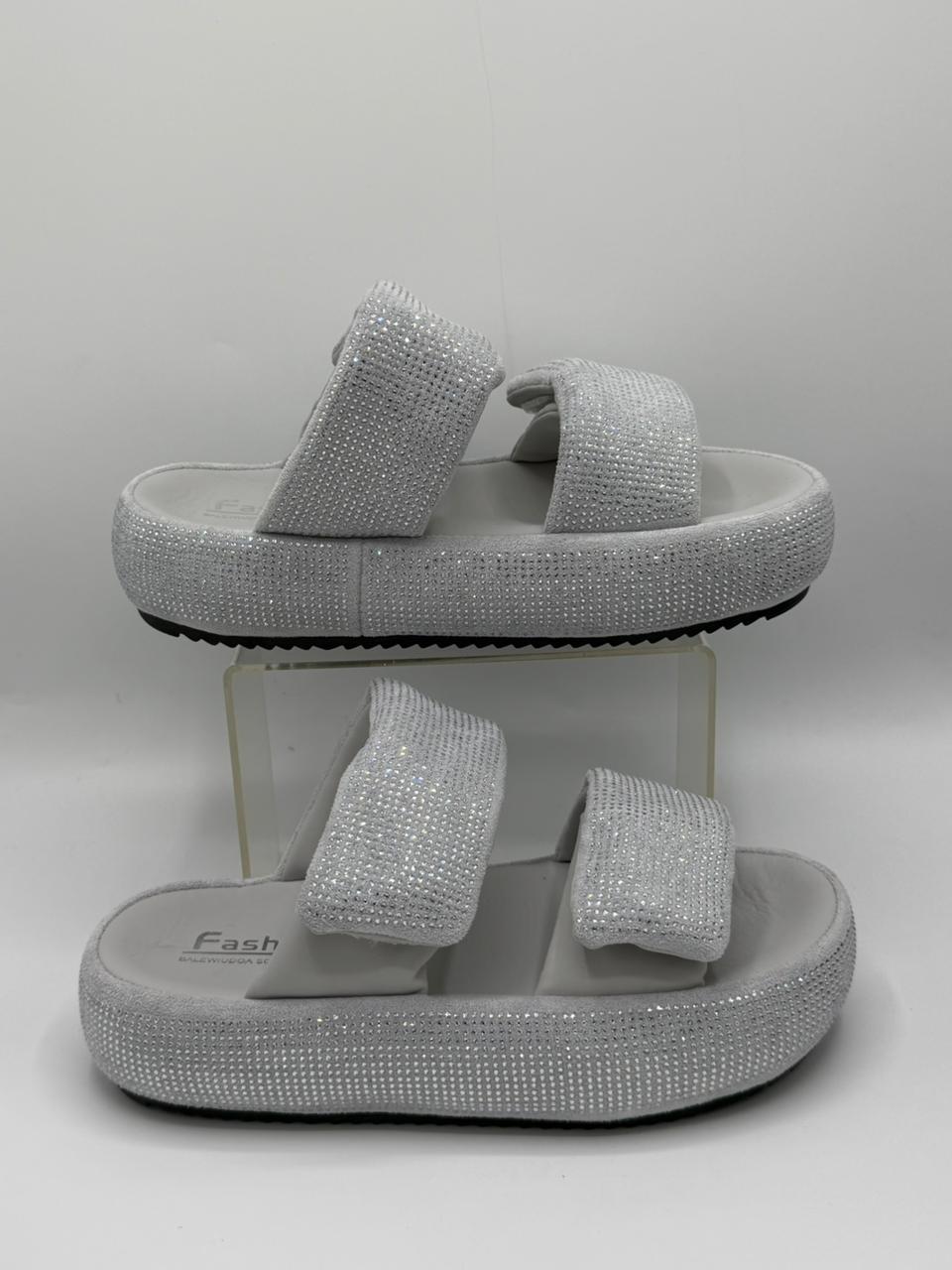 Silver glitter sandals on a white background