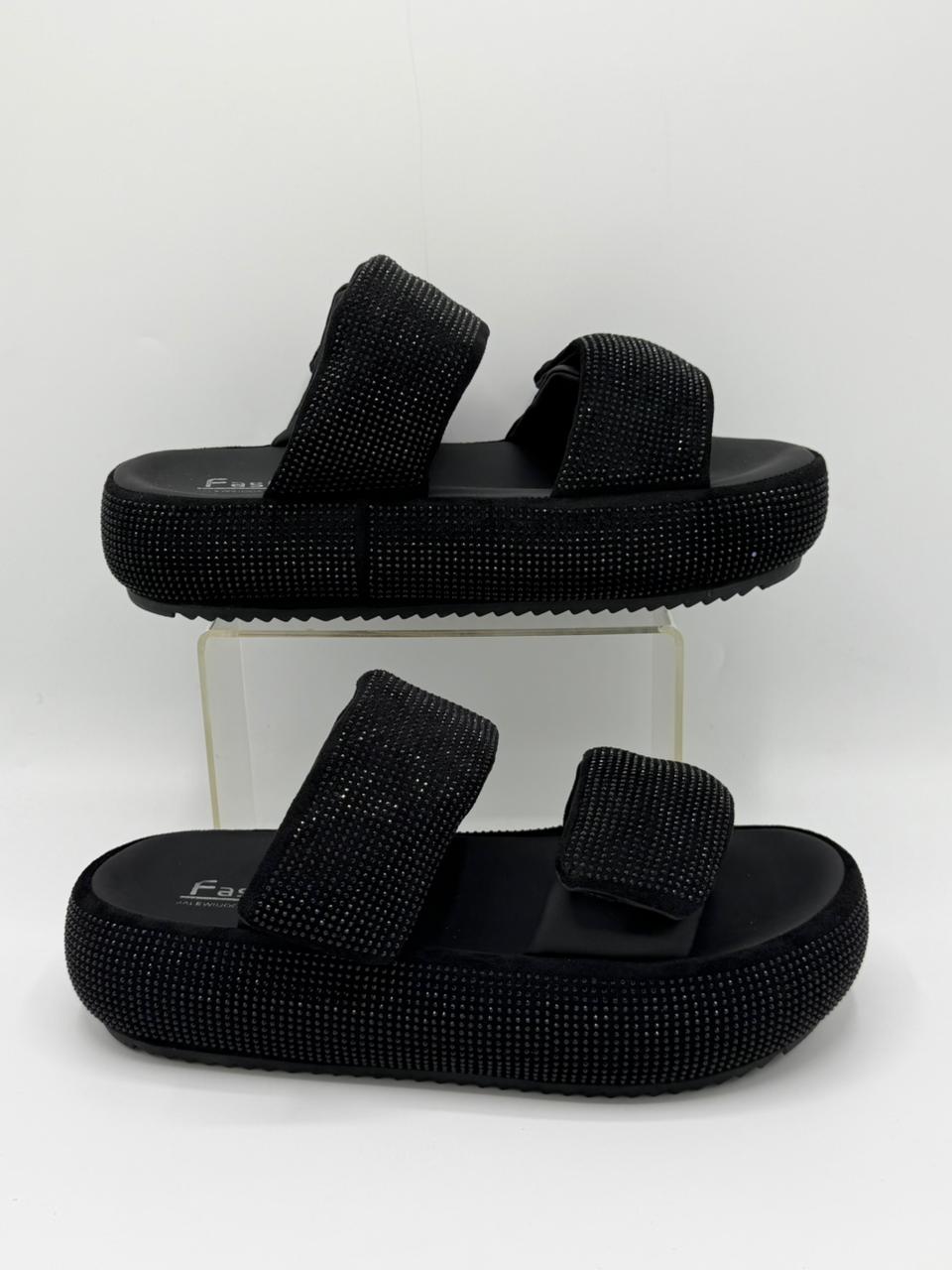 Black rhinestone sandals on a white background
