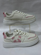 White sneakers with pink accents on a white background