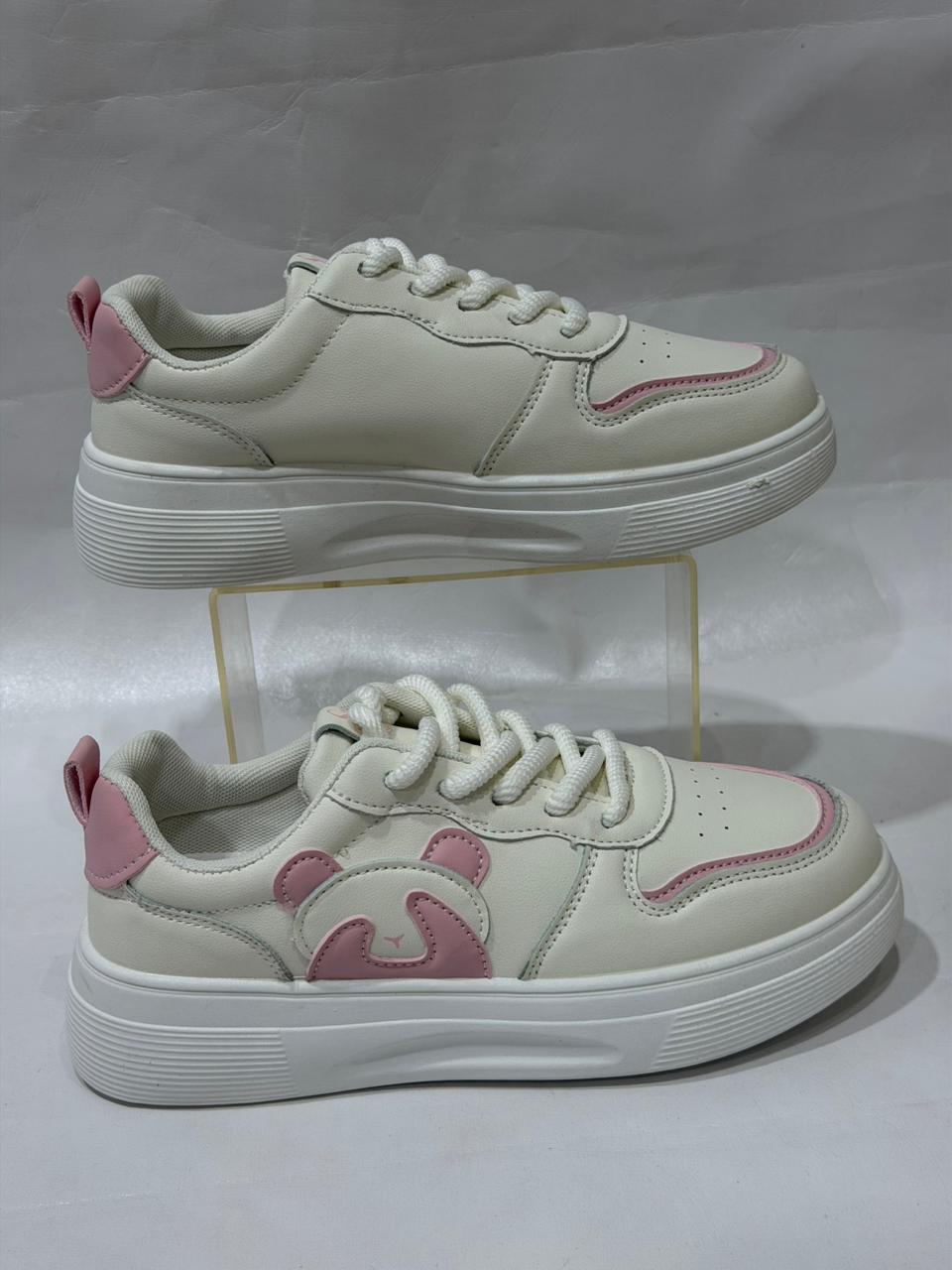 White sneakers with pink accents on a white background