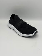 A black slip-on knit sneaker with a thick white sole, shown from a three-quarters angle on a light gray background.