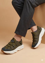 Person wearing green sneakers with white soles on a beige background
