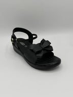 Black sandal with a bow on a gray background