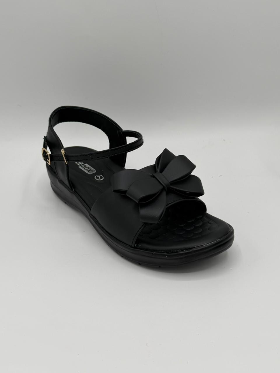 Black sandal with a bow on a gray background