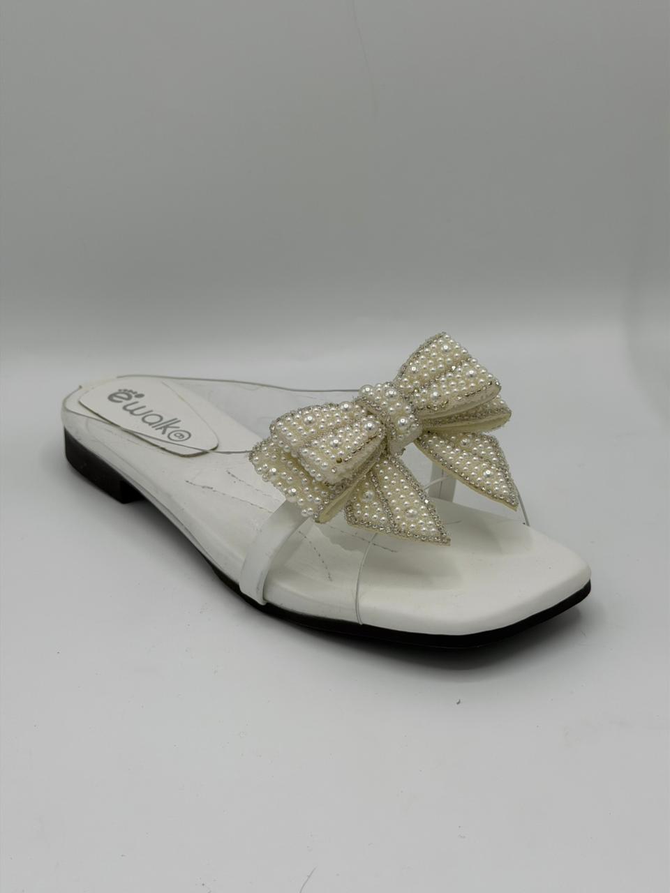 White sandal with a large pearl bow on a white background