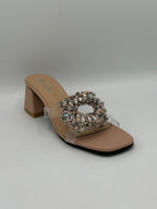 Beige high-heeled sandal with crystal embellishment on a gray background