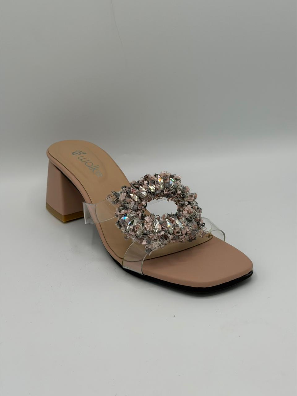 Beige high-heeled sandal with crystal embellishment on a gray background