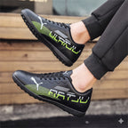Black sports shoes with green accents worn by a person on wooden steps.