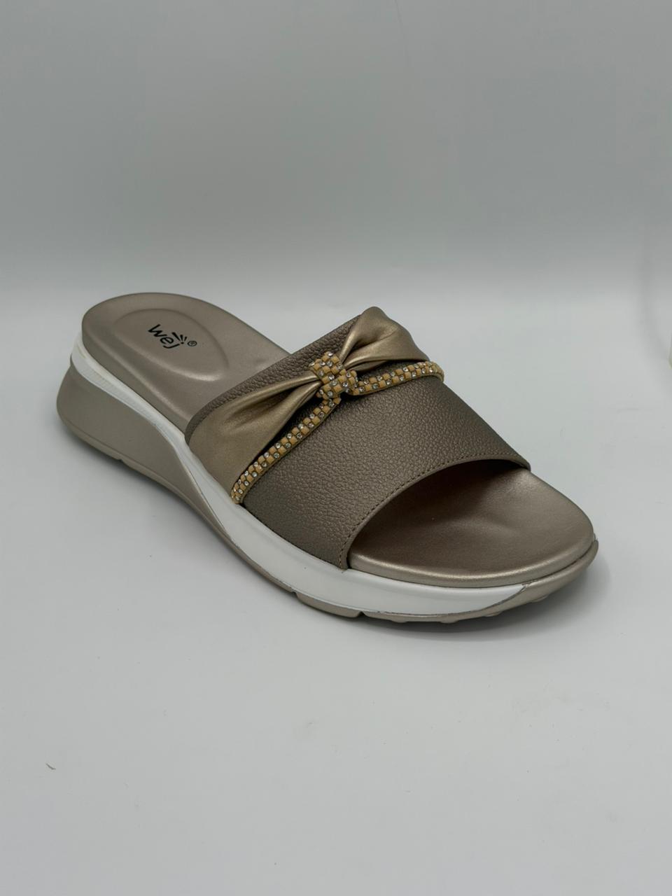 Brown sandal with a decorative bow on a gray background