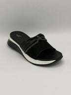 Black sandal with white sole on a gray background