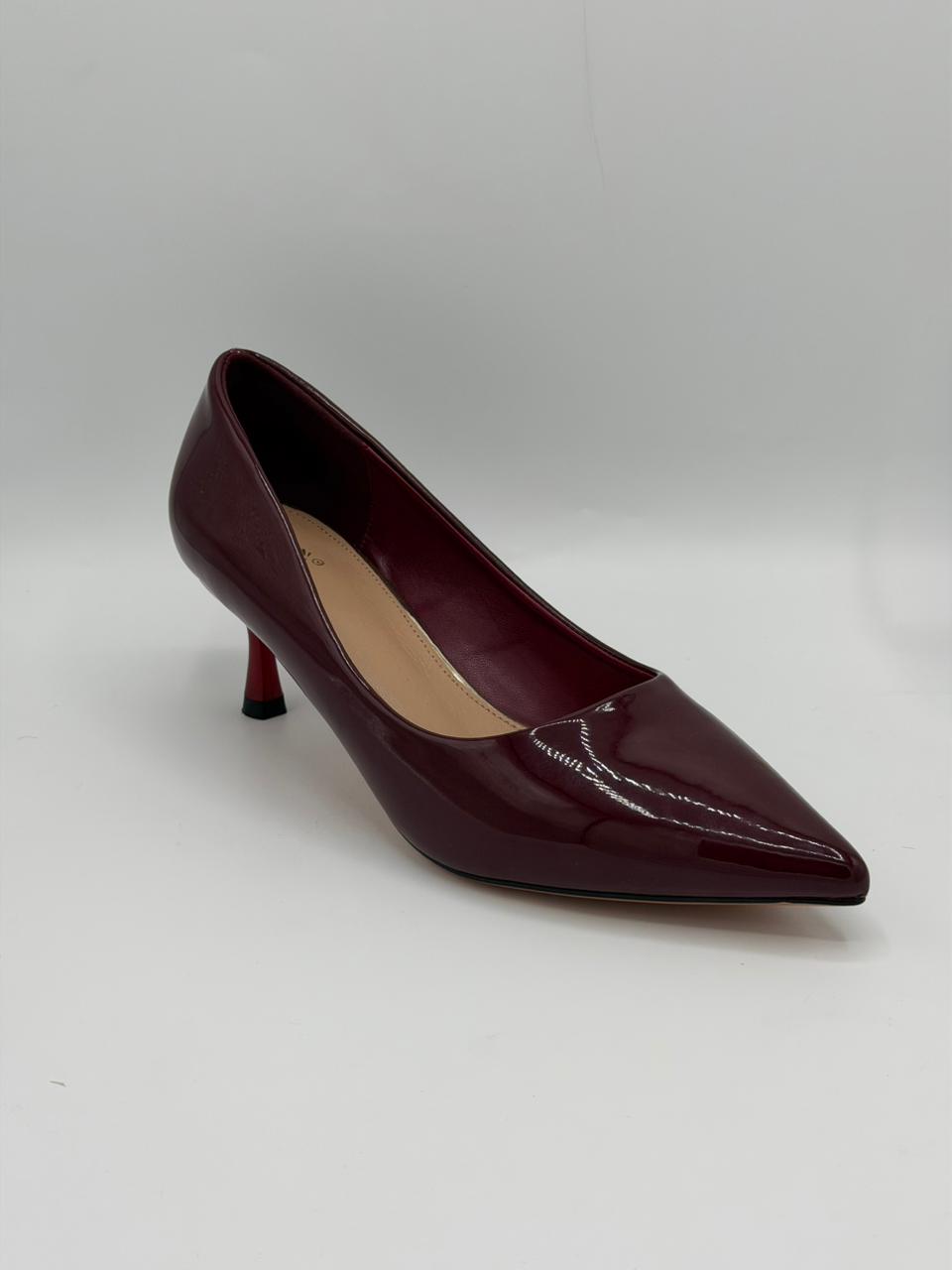 Maroon high-heeled shoe on a light gray background
