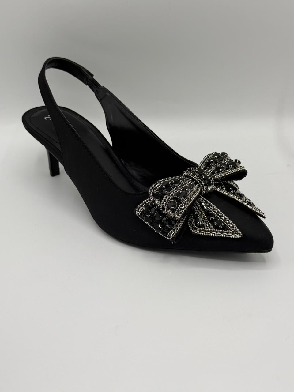 Black shoe with a decorative bow on a white background